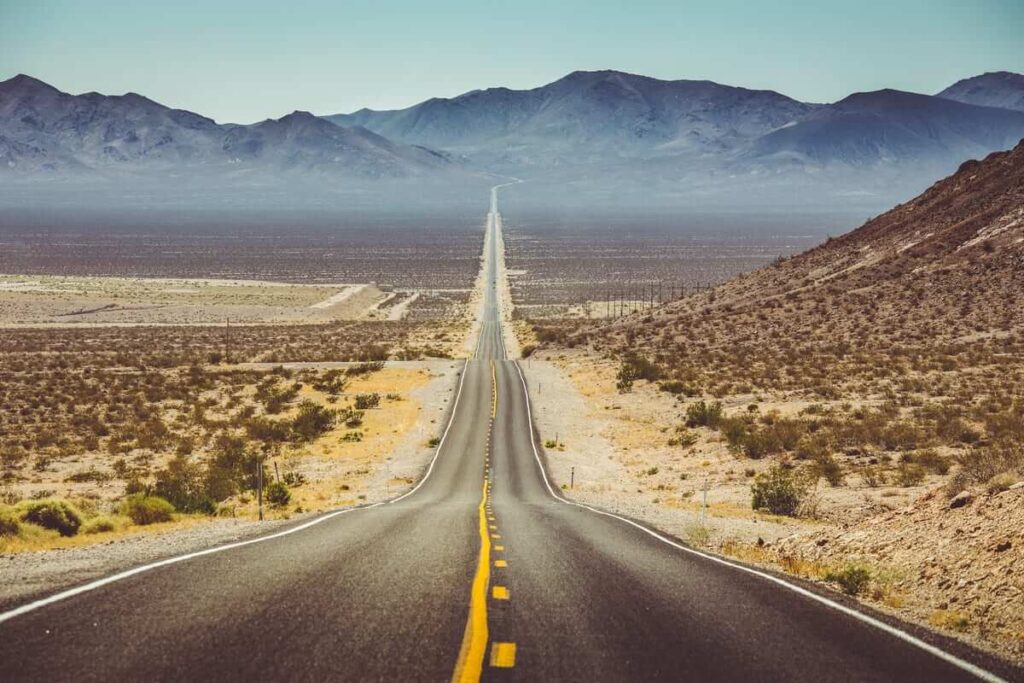 A highway stretching out of Las Vegas into the Arizona desert, symbolizing escape and new beginnings
