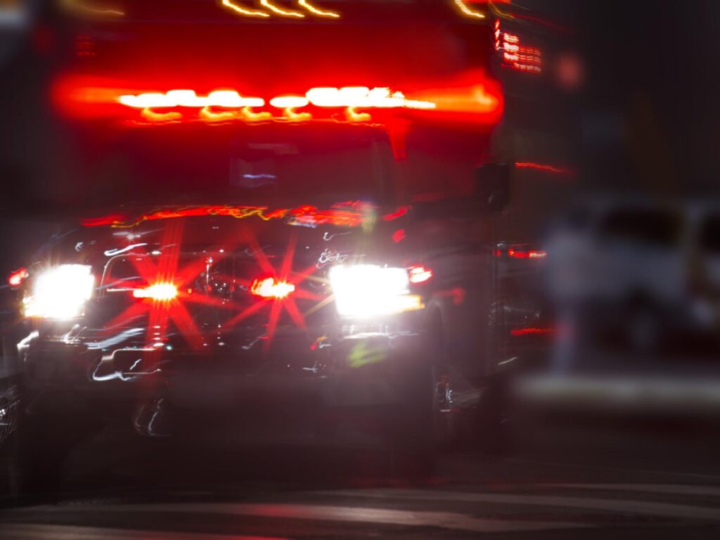 Arizona skyline with blurred ambulance lights in the foreground symbolizing rising overdose rates